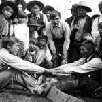 Two men playing a game called "Lazy Stick" during Dominion Day celebrations at Stuart Lake, Fort St. James